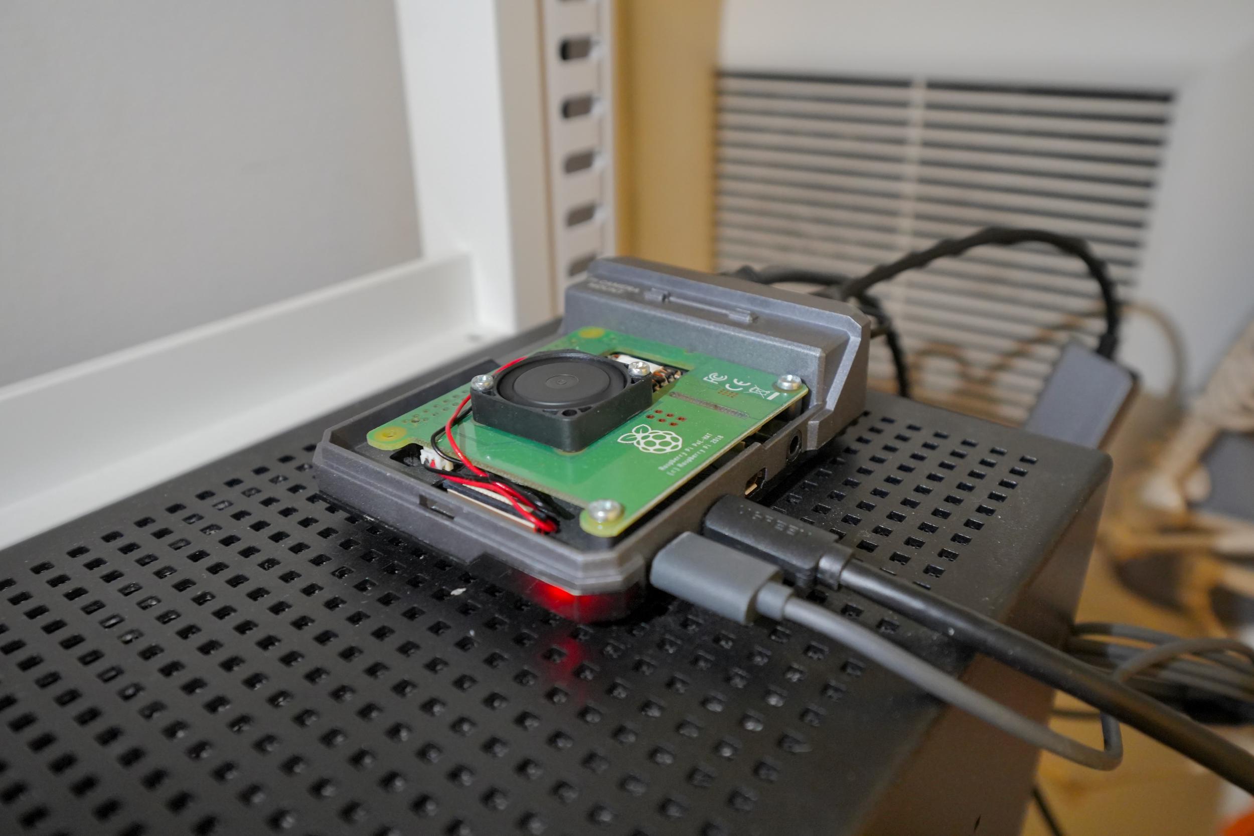 Close-up photo of the Pi plugged into the TV’s ARC HDMI input, HDMI adapters visible
